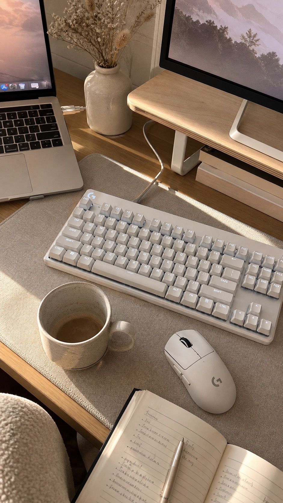 Desk detail from the cozy white gaming setup ideas for a soft-lit clean desk space featuring Logitech G PRO X TKL Keyboard, Logitech G PRO X Superlight 2 Mouse, ceramic decor, and warm window light