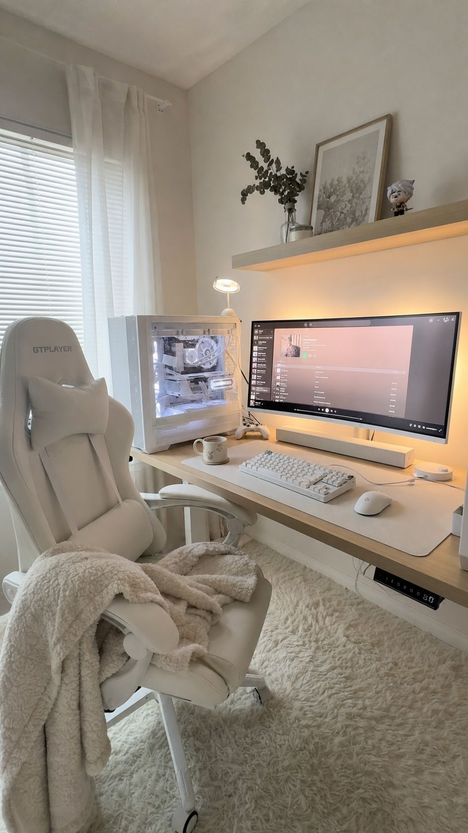 Diagonal view of a cozy white gaming setup with white peripherals and white PC case